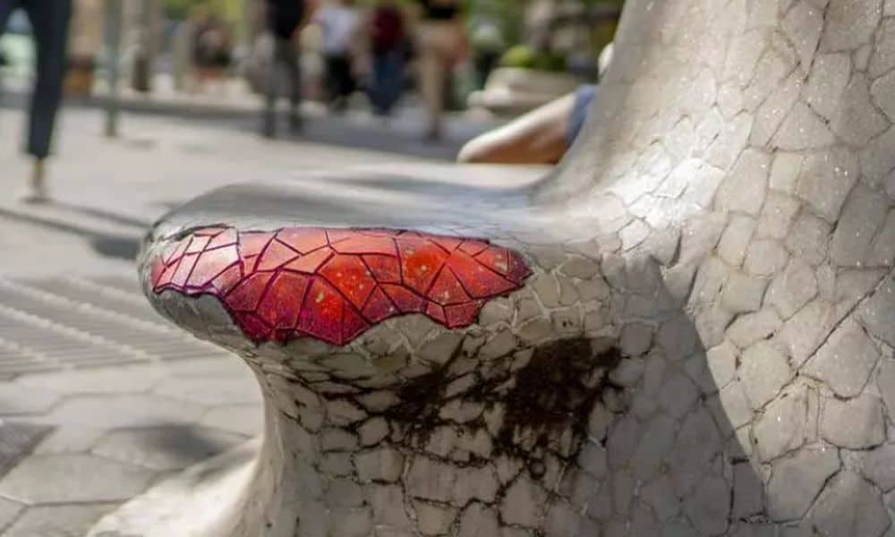 Benches on Barcelona's Passeig de Gràcia are restored with graffiti patches by a street artist